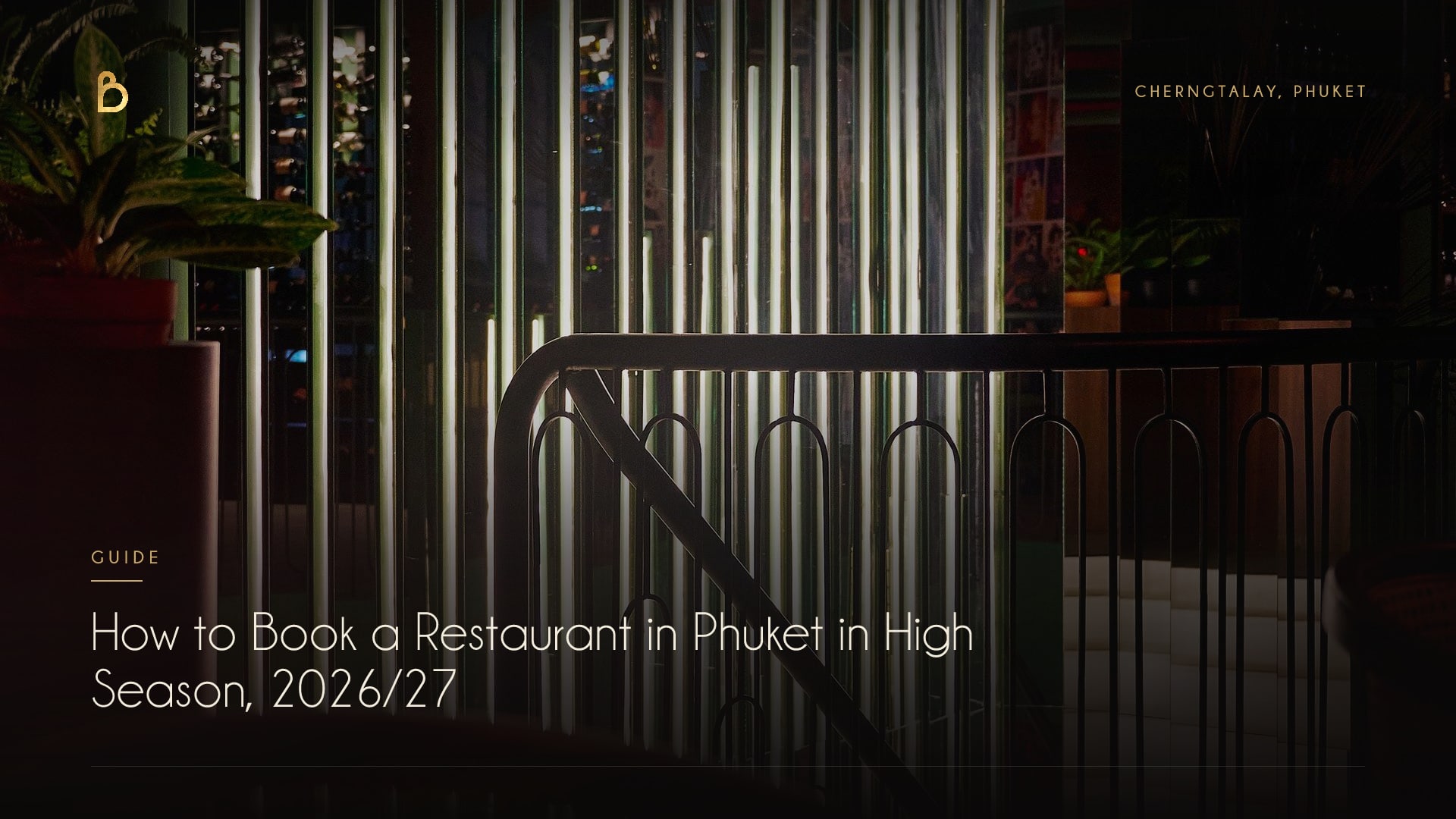 The staircase railing and lit glass panels inside Bisou Phuket, a modern French restaurant and cocktail bar in Cherngtalay