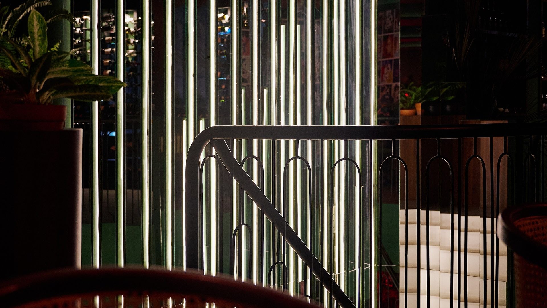 The lit facade of Bisou, a modern French restaurant on Bandon-Cherngtalay Road near Bang Tao Beach, open late for dinner and cocktails